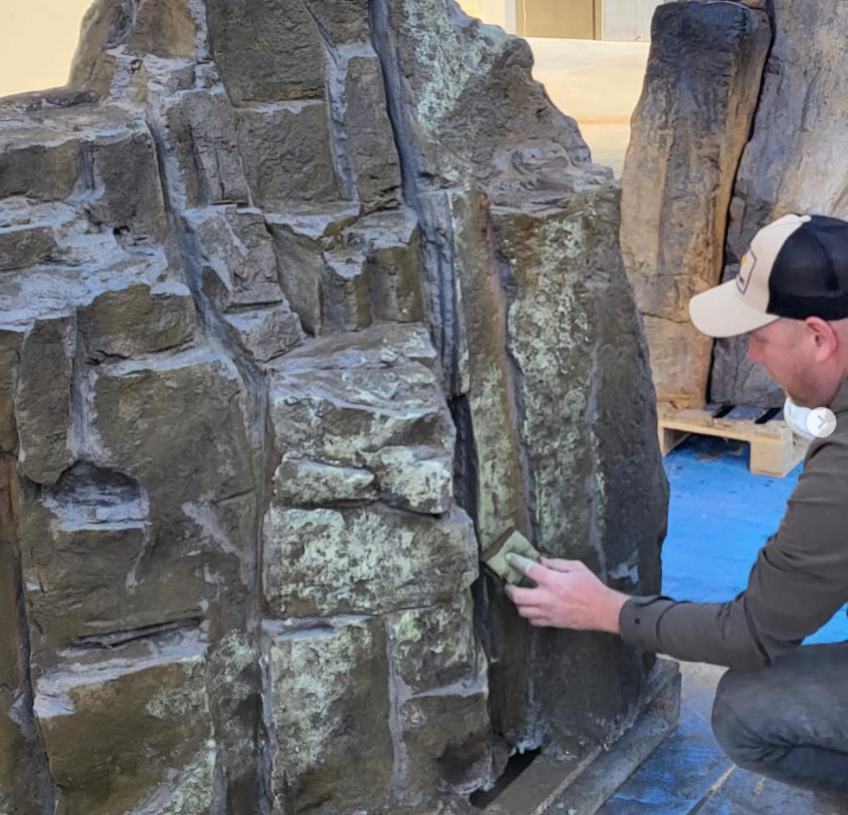 Finishing stonework detail by hand during a project