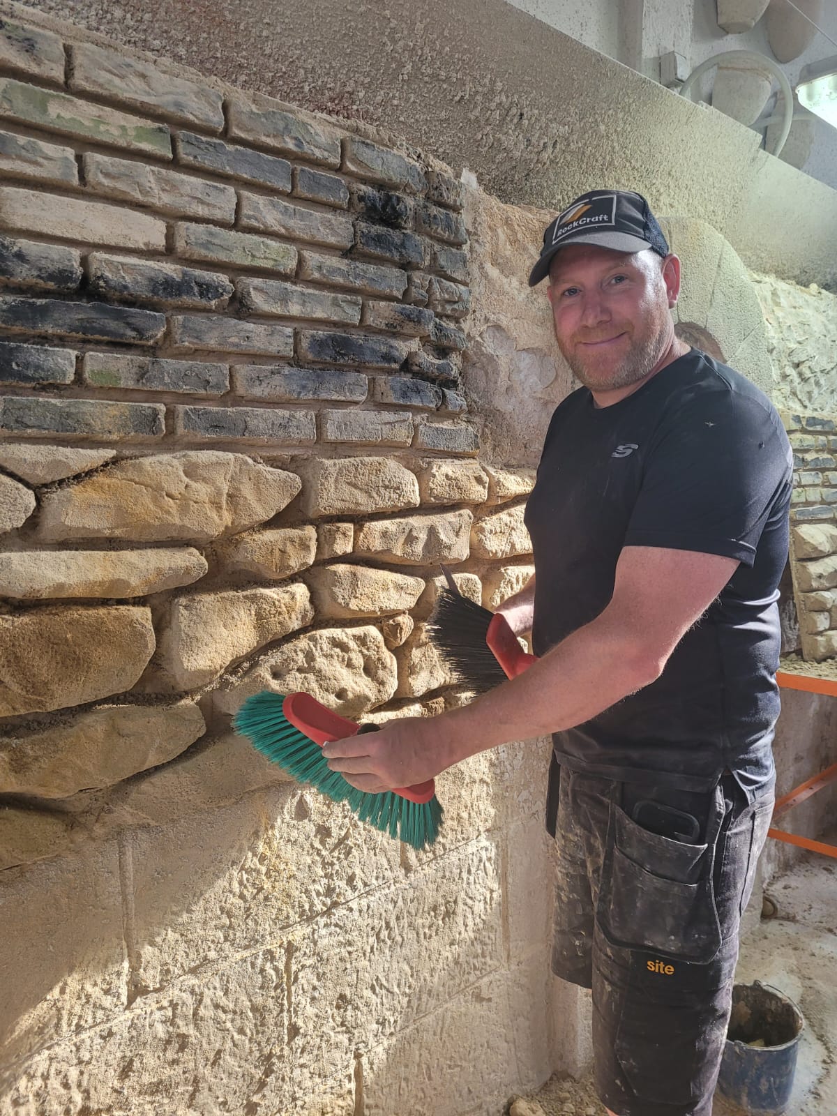Adrian from RockCraft finishing a hand-crafted stone wall