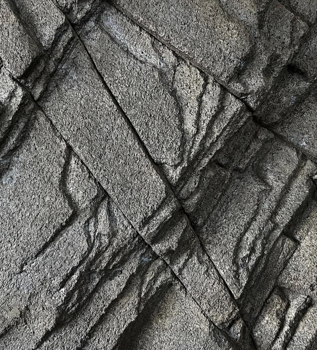 Close-up of hand-carved grey rock texture