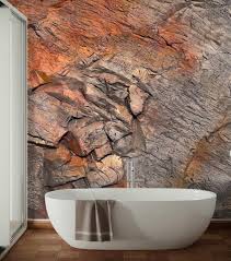 Textured rock feature wall beside a freestanding bath