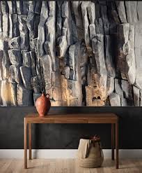 Dramatic rock wall feature behind a wooden console table