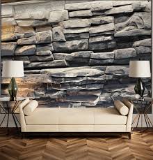 Layered grey stone feature wall behind a cream sofa