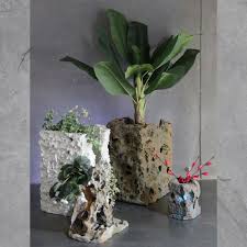 Hand-crafted stone planters with greenery